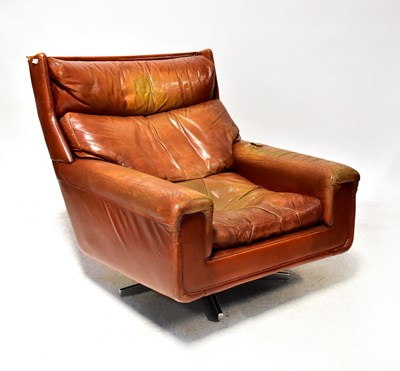 Lot 8 - A retro oversized tan leather lounge chair...