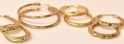 Lot 613 - Four pairs of 9ct yellow gold hollow hoop...