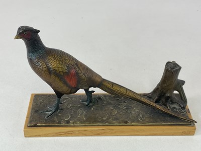 Lot 23 - A cold painted spelter table striker in the...