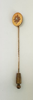 Lot 649 - A Victorian yellow metal stickpin set with...