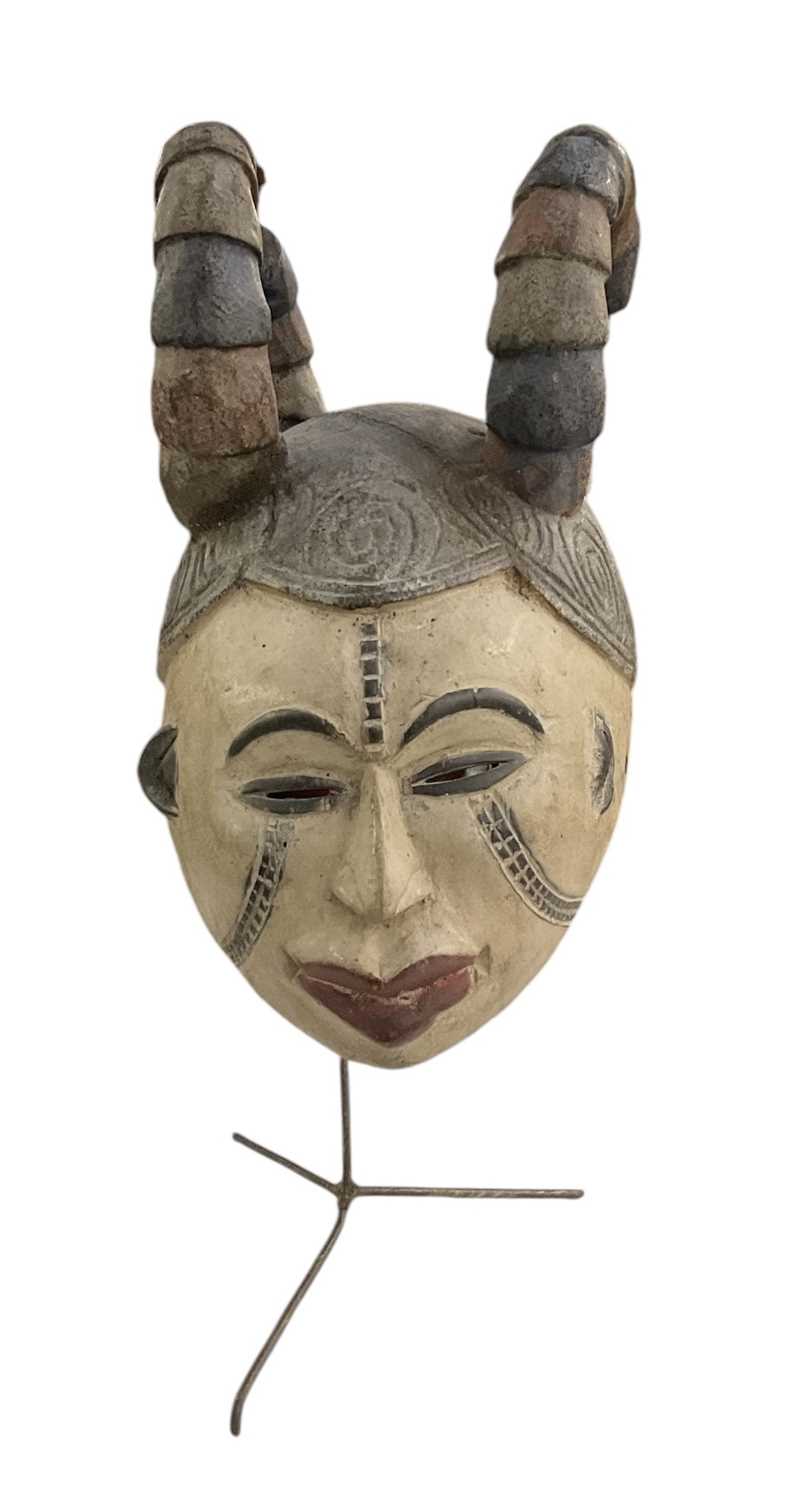 Lot 1045 - An African carved wooden Igbo maiden mask, on...