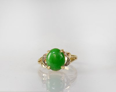 Lot 838 - A 14ct yellow gold ring set with an oval green...