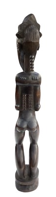Lot 1095 - A tall African carved wooden Baule figure,...