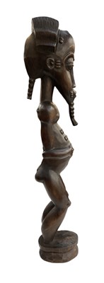 Lot 1095 - A tall African carved wooden Baule figure,...