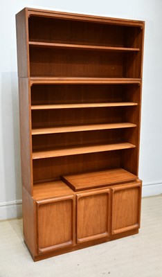 Lot 65 - A mid century teak bookcase, the upper section...