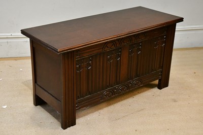 Lot 206 - WARING & GILLOW; a carved oak blanket chest...