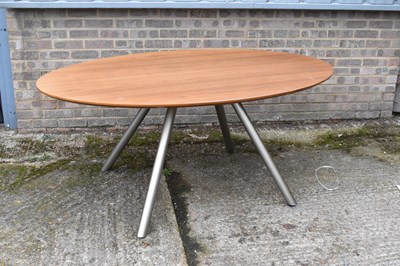 Lot 82 - A teak oval table on four metal supports, 174...