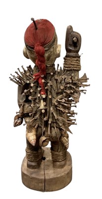 Lot 1073 - An African carved wooden Nkisi nail fetish...