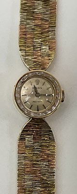 Lot 658 - ROLEX; a lady's vintage 9ct tricolour gold...