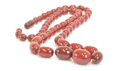 Lot 589 - A large cherry amber graduated bead necklace,...