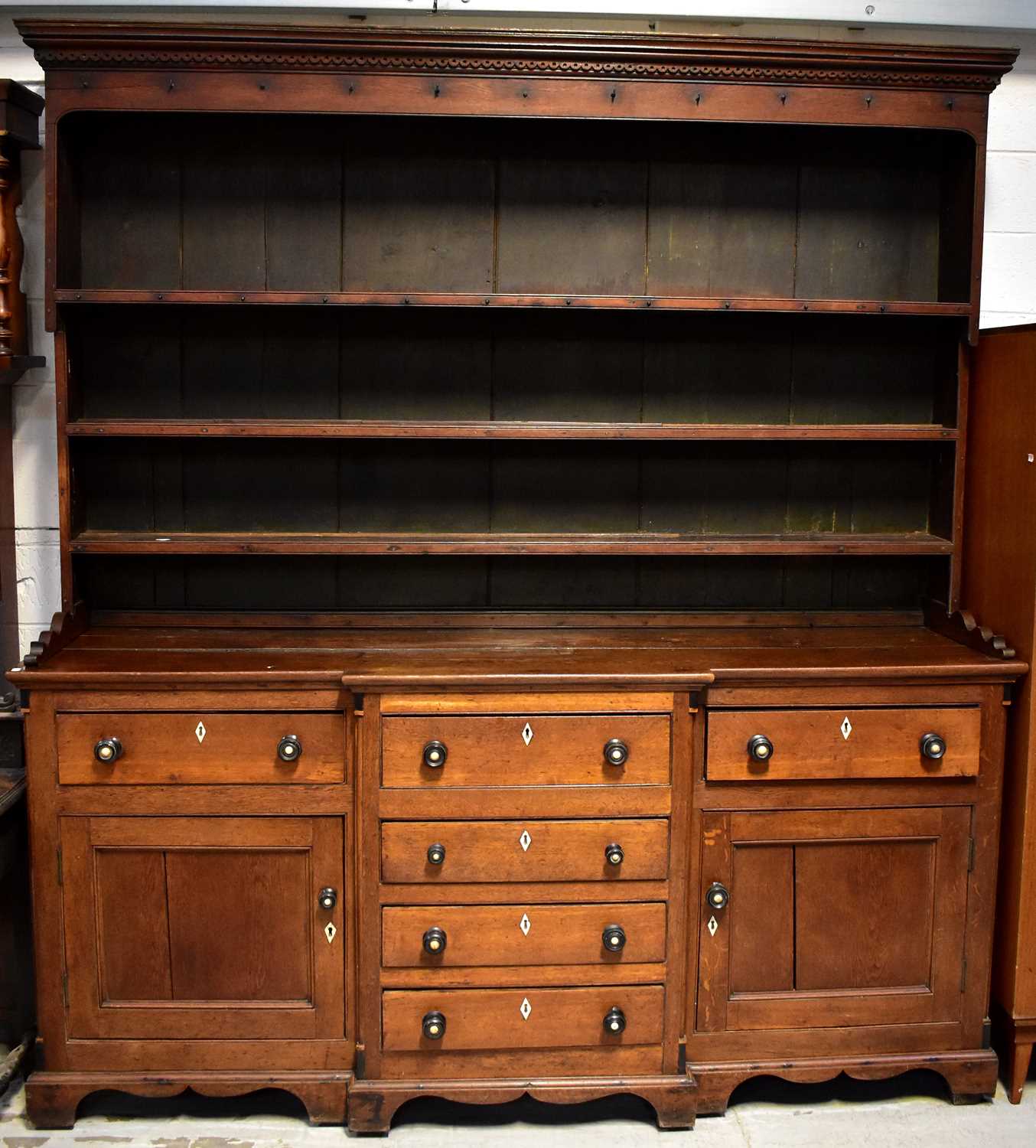 Lot 16 - A George III oak dresser with an enclosed...