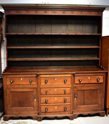 Lot 16 - A George III oak dresser with an enclosed...