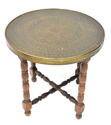 Lot 38 - An Indian brass tray top table with embossed...