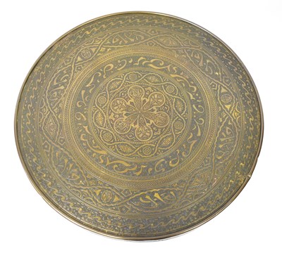 Lot 38 - An Indian brass tray top table with embossed...