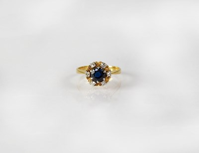 Lot 828 - An 18ct yellow gold diamond and sapphire...