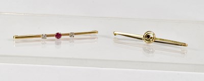 Lot 875 - A 9ct yellow gold bar brooch set with a ruby...