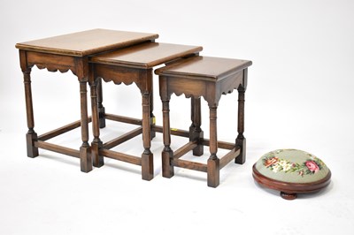 Lot 82 - A reproduction nest of three oak tables in the...