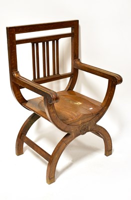 Lot 59 - An oak Savonarola-type open arm elbow chair,...