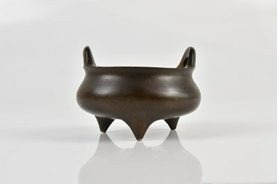 Lot 1050 - A Chinese bronze censer with two loop handles...