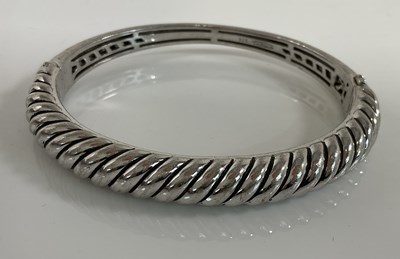 Lot 643 - TI SENTO; a silver hinged oval bangle,...