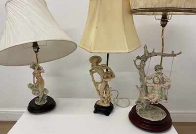 Lot 715 - CAPODIMONTE; two figural lamps, together with...