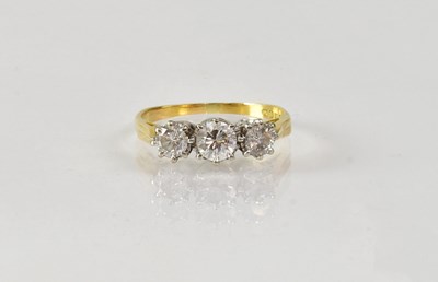 Lot 821 - An 18ct yellow gold three-stone diamond ring,...