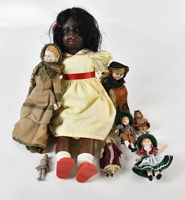 Lot 950 - A vintage black doll with painted lips, open...