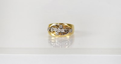 Lot 835 - An 18ct yellow and white gold ring...