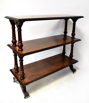 Lot 75 - A Victorian walnut three-tier buffet on turned...