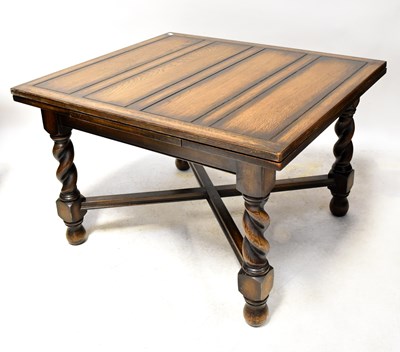 Lot 76 - A 1930s oak extending dining table on bulbous...