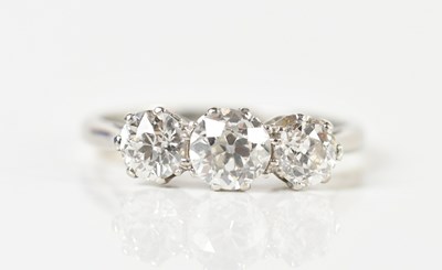 Lot 1278 - A platinum and diamond three stone ring, the...