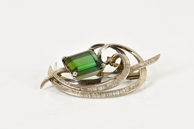 Lot 1244 - A white metal and tourmaline swept brooch with...