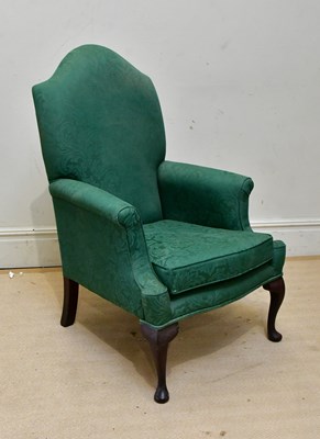 Lot 221 - A 20th century wingback armchair, upholstered...