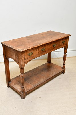 Lot 42 - A reproduction oak dresser base, with three...