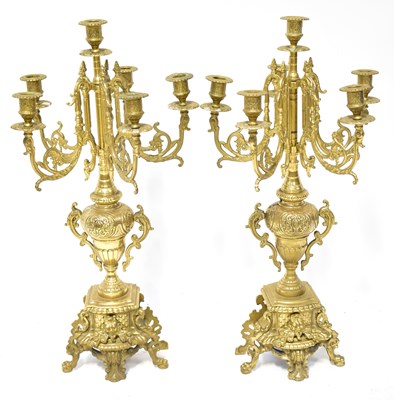 Lot 149 - A pair of five-branch candelabra with scroll...