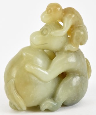 Lot 725 - A Chinese carved green jade figure of two...