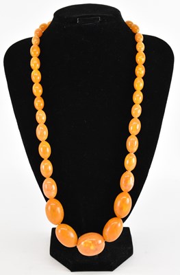 Lot 886 - A butterscotch amber effect bead necklace,...