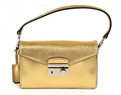 Lot 670A - PRADA; a gold saffiano leather mini sound bag...