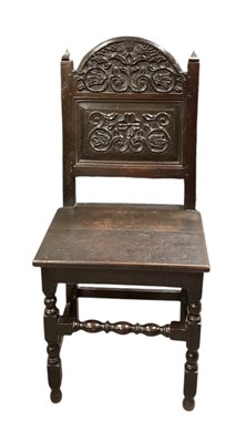 Lot 21 - A 17th/18th century carved oak hall chair,...