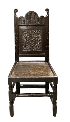 Lot 22 - A 17th century carved oak hall chair, with...