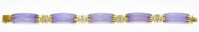 Lot 1262 - A Chinese 14ct yellow gold and lavender jade...
