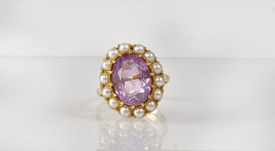 Lot 844 - A 9ct gold cluster ring set with central oval...