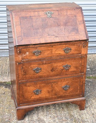 Lot 67 - A small walnut bureau, the fall front...