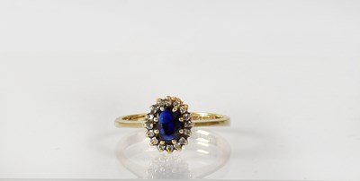 Lot 839 - A 9ct gold cluster ring set with central...