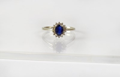 Lot 843 - A 9ct white gold ring set with sapphire in a...