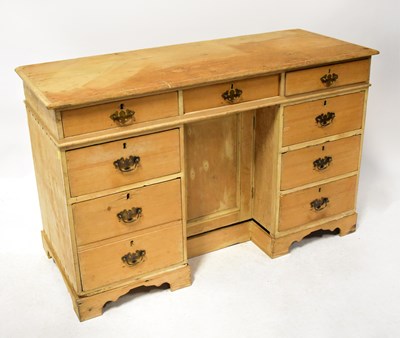 Lot 96 - A rustic pine desk, the three-drawer top above...