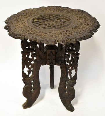 Lot 61 - An Indonesian-style hardwood table with carved...