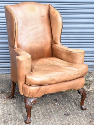 Lot 16 - A Georgian style leather upholstered wing...