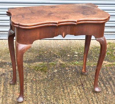 Lot 7 - A George II mahogany tea table, the shaped...