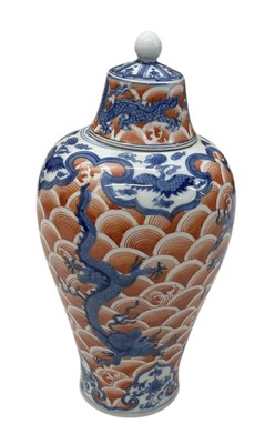 Lot 1019 - A Chinese porcelain vase with cover, the red...